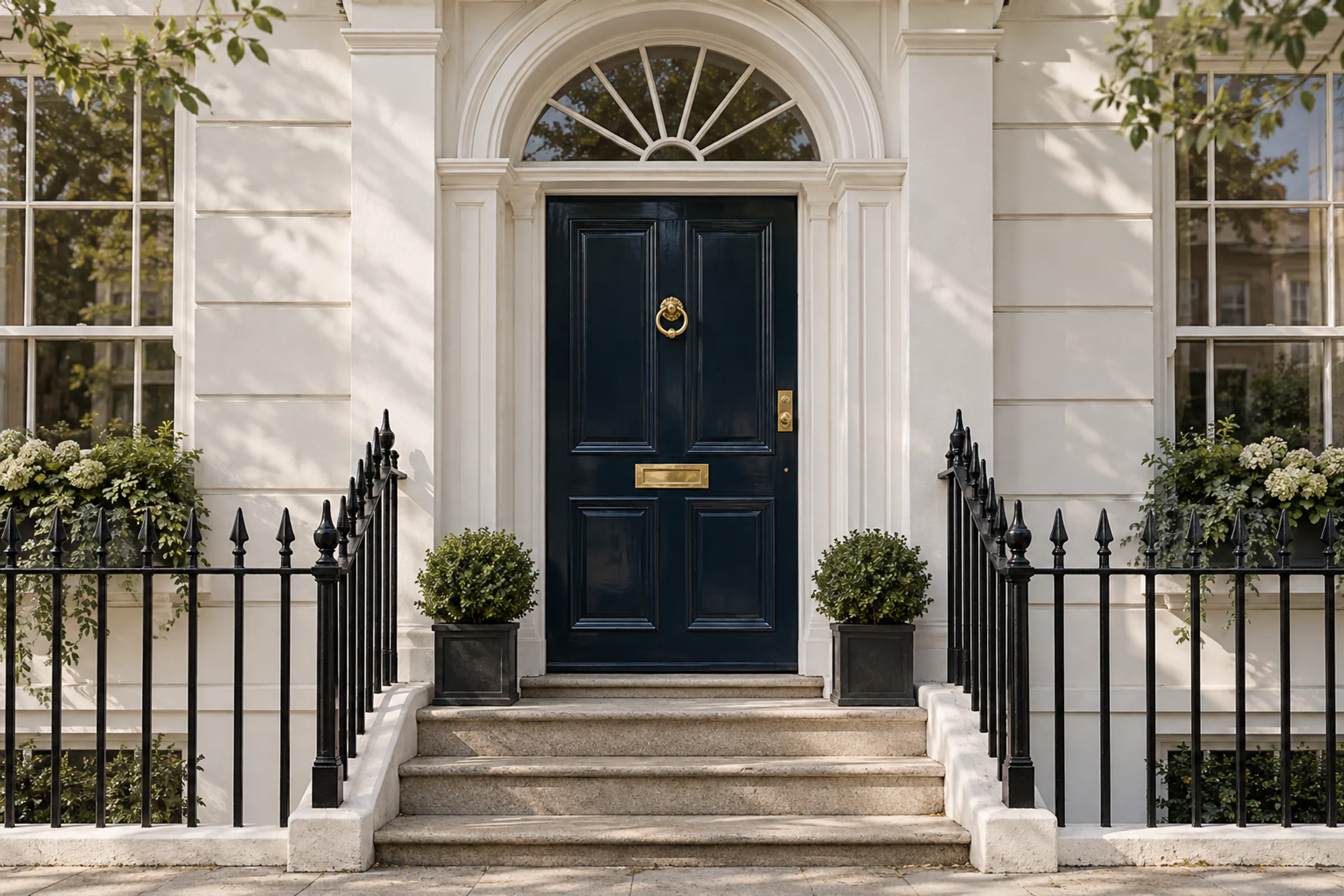 A glossy navy front door on a white stucco Notting Hill terrace